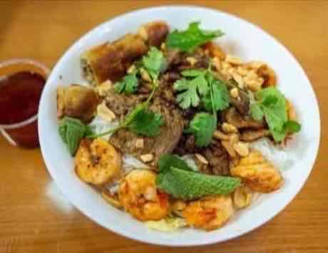 Vermicelli bowl with grilled beef, shrimp, egg roll, peanuts and mint