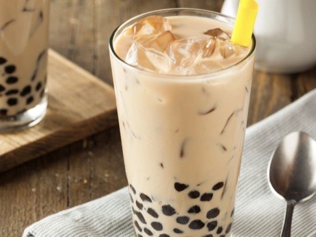 Iced bubble tea with chewy tapioca pearls in a tall glass