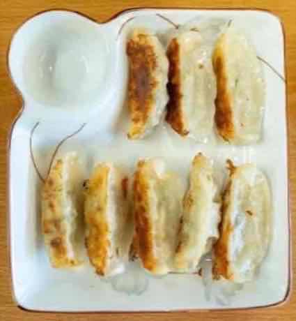 Plate of pork and shrimp dumplings with dipping sauce