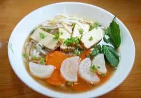 Vegetarian noodle soup with tofu, daikon, carrot and Thai basil