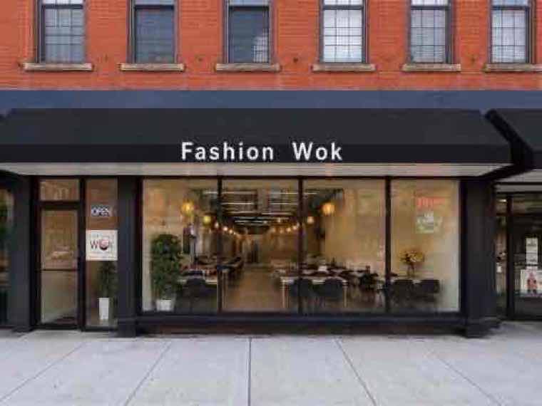 Newly renovated Fashion Wok storefront with black awning and large windows in Middletown, NY